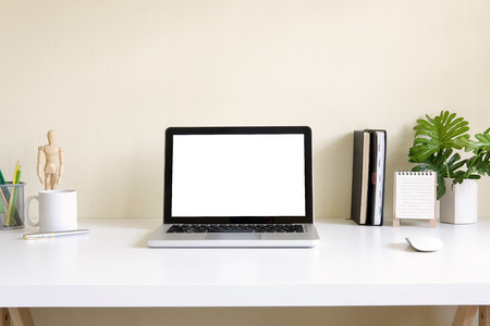 Mockup blank screen computer laptop on desk. Workspace with laptop and office supplies.の写真素材
