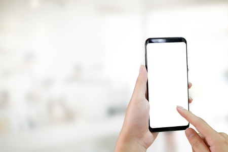 Hands using smartphone mockup is empty screen and blur background.の写真素材