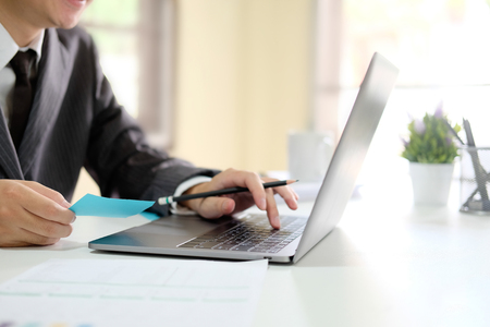 Businessman working with computer laptop with lighting morning and side view photo.の写真素材