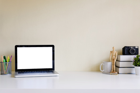 Mockup blank screen computer laptop on desk. Workspace with laptop and office supplies.の写真素材
