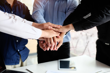 Business team putting their hands together cooperation success business.の写真素材