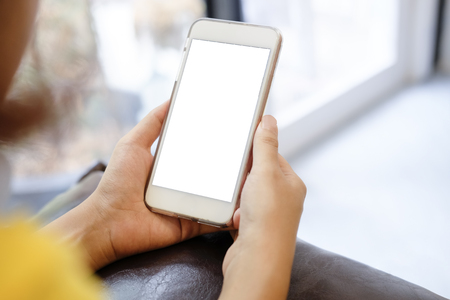 Mockup image of woman hand holding mobile phone with blank white screen.の写真素材