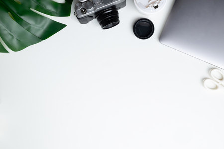 Overhead office laptop computer, camera and coffee take away cup. Top view workspace.の写真素材