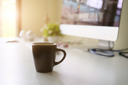 Mug of coffee on office workplace with morning coffee concept.の写真素材