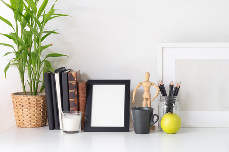 Stylish workspace with poster, book and gadget. Workplace desk and copy space.