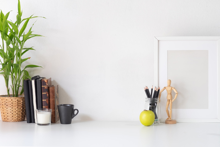 Stylish workspace with poster, book and gadget. Workplace desk and copy space.の写真素材