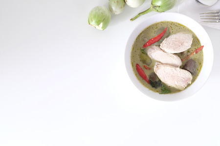 Green curry soup with top view on white table and copy space.の写真素材