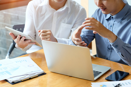 Asian Business partner working with laptop, Two colleagues discussion with business consult.の写真素材