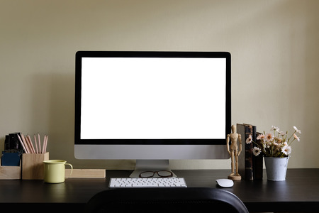 Workspace with Computer display and office tools on black table. Desktop computer screen isolated. Modern creative desk with flower . Front view.の写真素材