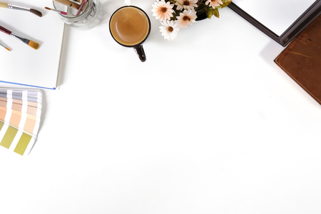 Top view office desk with designer table a Pantone, coffee and notebook paper sketch on white table artist workspace above view.の写真素材