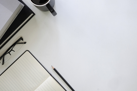 Copy space table with book, coffee cup, pencil,notebook and glasses on desk.の写真素材