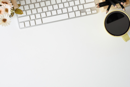 Office desk computer keyboard, pencil, flower and coffee mug on workspace white table and copy space.の写真素材