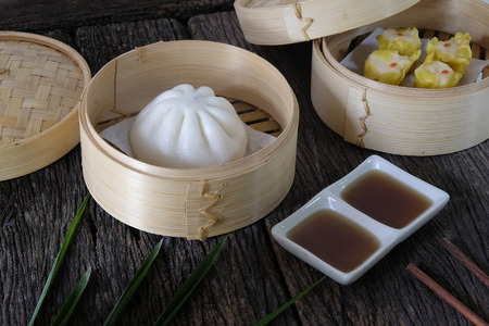Hot buns dim sum on wooden table.の写真素材