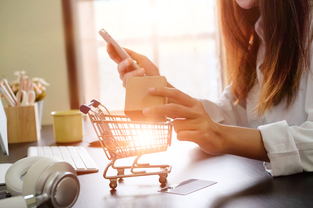 Boxes in a trolley with Woman hands, Shopping online concept.の写真素材