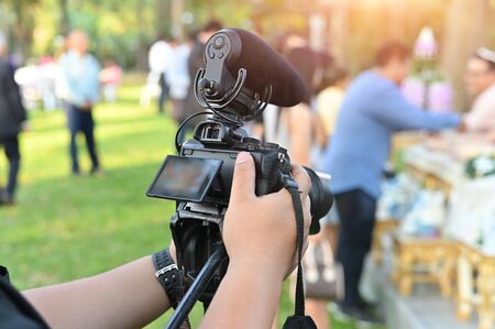 The photographer Video camera operator working with his equipment to pay close attention to take a...