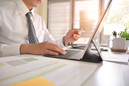 Businessman analysis in digital tablet on office desk.の写真素材
