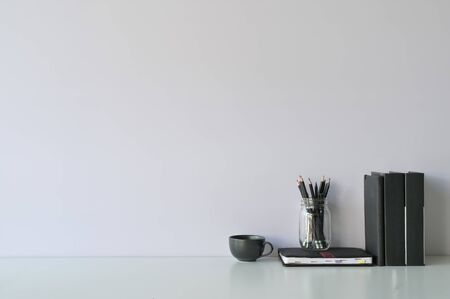 Mockup workspace desk and copy space books, coffee and pencil on white desk.の写真素材