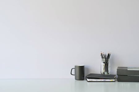 Mockup workspace desk and copy space books, coffee and pencil on white desk.の写真素材