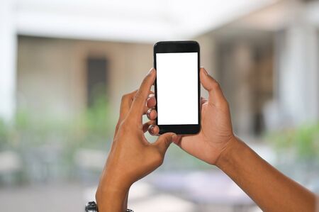 Mockup mobile phone on hands with blur background.の写真素材