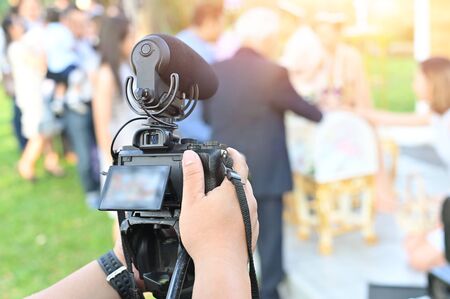 The photographer Video camera operator working with his equipment to pay close attention to take a photo.の写真素材