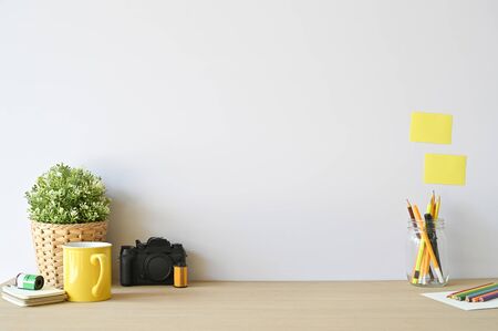 Creative workspace camera and office supplies on wood desk with copy space.の写真素材
