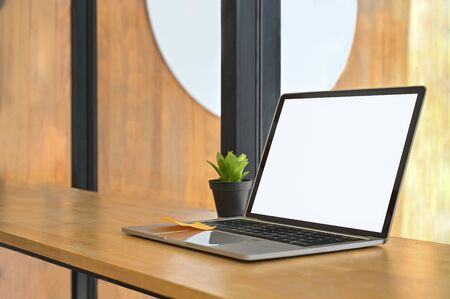 Laptop computer isolated white screen on wood shelf.の写真素材