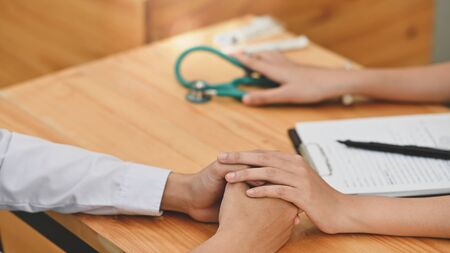 Close-up Doctor holding a patient 
comforting with Serious illness.の写真素材
