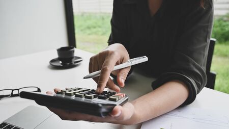 Finance concept, woman calculation finance data on table.の写真素材