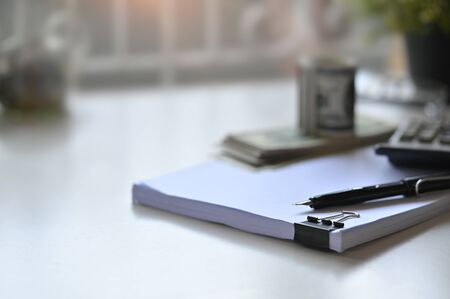 Saving concept with document paper, pen and calculator on home table.の写真素材