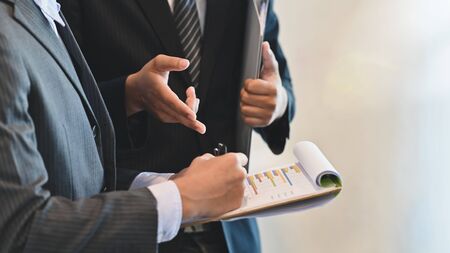 Closeup colleague businessman discussion with finance report.の写真素材
