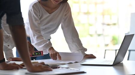 Cropped shot Architect planning blueprint in laptop computer with construction meeting and planning concept.の写真素材