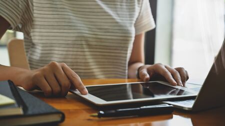 Close-up female using her digital tablet.の写真素材