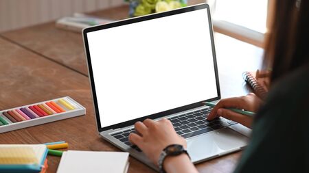 Creative woman working with mockup laptop computer.