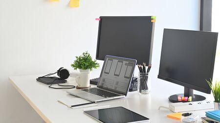 Workspace programmer with laptop and computer pc on table.の写真素材