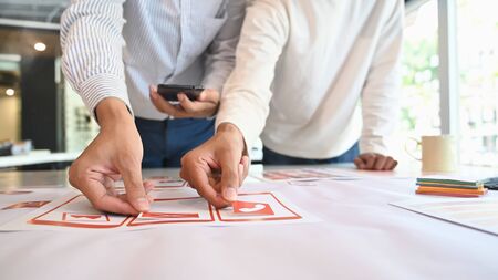 App developer Ux Ui designing with paper model on mobile application prepare, Close up shot.の写真素材