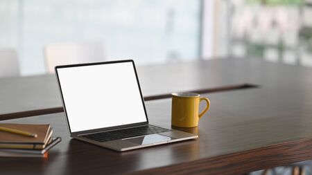 Mockup laptop computer isolated white screen on meeting room.の写真素材