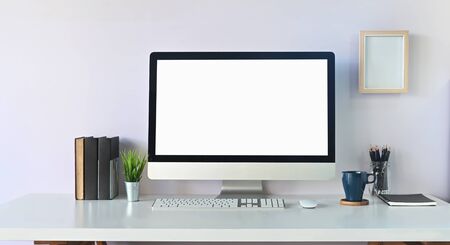 Comfortable workspace with pc computer and creative accessories with coffee on white table.の写真素材