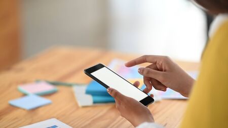 Young women are using white blank screen smartphone.の写真素材