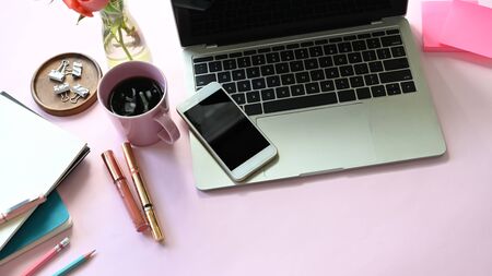 Top view of woman table with accessories and woman cosmetic putting on it. Computer laptop, smartphoneの写真素材