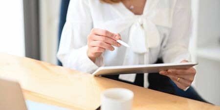 Photo of beautiful attractive girl holding/using a stylus pen for drawing/planning to computer...