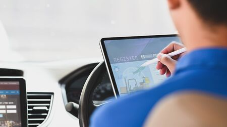 Cropped image of delivery man using a stylus pen and computer tablet for checking address of parcel...