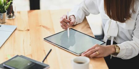Photo of beautiful attractive girl holding/using a stylus pen for drawing/planning to computer...