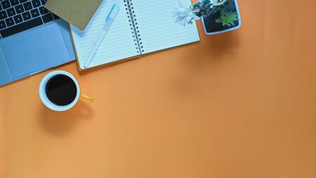 Top view image of computer laptop, coffee cup, pen, notebook, potted plant putting together on working desk. Orderly workplace concept.の写真素材