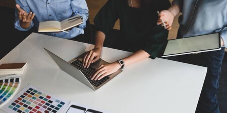 Top view image of graphic designing team working together and brainstorming about new feature on smartphone. Collaboration/Co worker/Conference/Working together concept.の写真素材