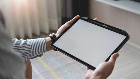 Women are showing how to make up via online video at the wooden dressing table.の写真素材