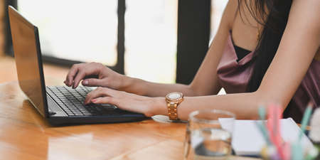 Women are showing how to make up via online video at the wooden dressing table.の写真素材