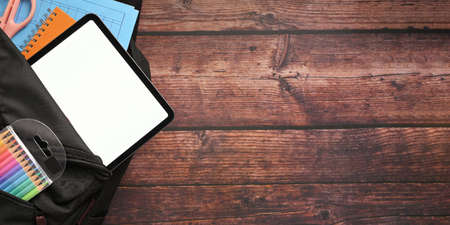 Black screen tablet in school backpack with education supplies.の写真素材