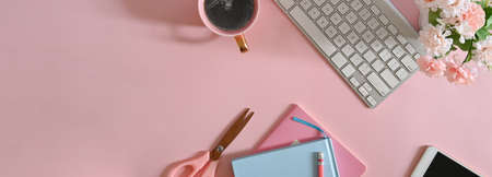 Cropped image hands are using a computer laptop while sitting at the wooden working table.の写真素材