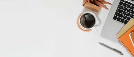 A beautiful woman is sketching on a computer tablet in hand while sitting in a comfortable coffee cafe.の写真素材