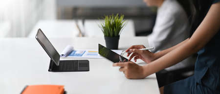 Female hand using digital drawing tablet in her office.
